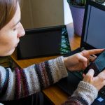 kobieta pracująca z notebookem w miejscu pracy cyfrowy tablet telefon komórkowy kawa i rośliny