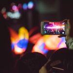 person taking photo of pink light