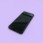 a close up of a cell phone on a purple surface