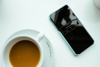 a cup of coffee and a cell phone