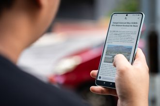 a person holding a cell phone in their hand