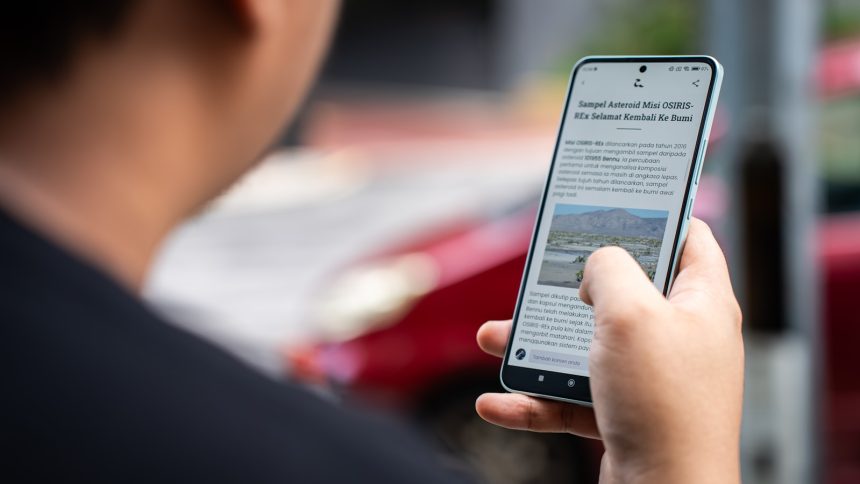 a person holding a cell phone in their hand