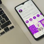 a cell phone sitting next to a laptop computer