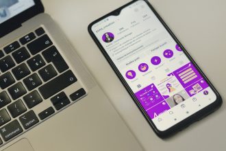 a cell phone sitting next to a laptop computer