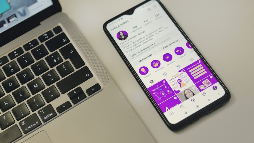 a cell phone sitting next to a laptop computer