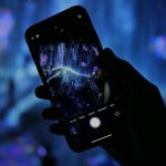 a person holding a cell phone in their hand