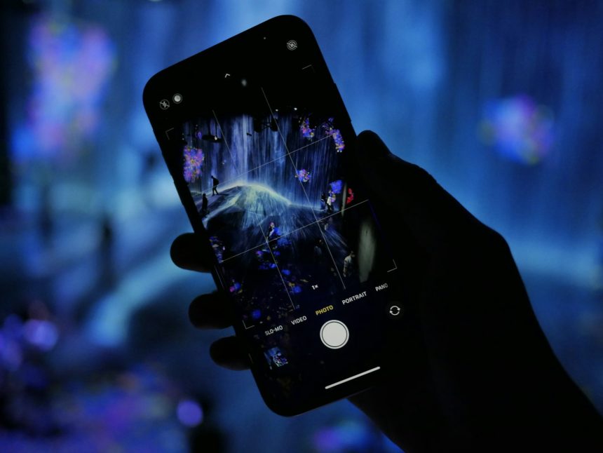 a person holding a cell phone in their hand