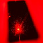 a cell phone with a red light shining on it