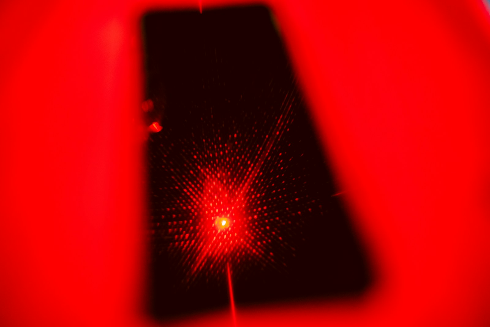 a cell phone with a red light shining on it