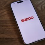 A badoo phone sitting on top of a wooden table
