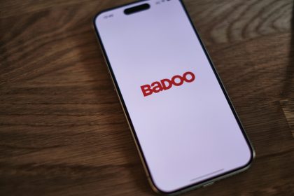 A badoo phone sitting on top of a wooden table