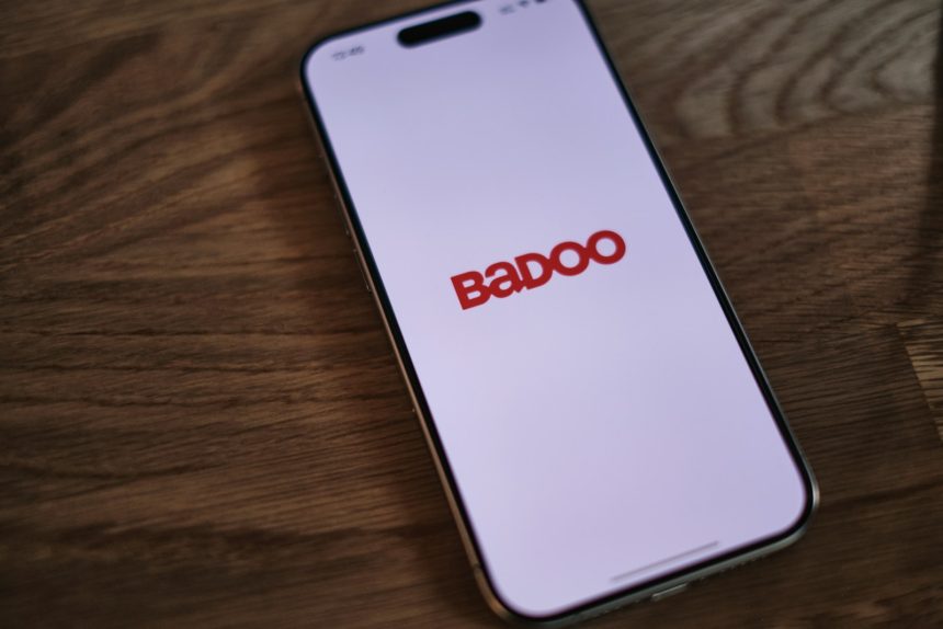 A badoo phone sitting on top of a wooden table