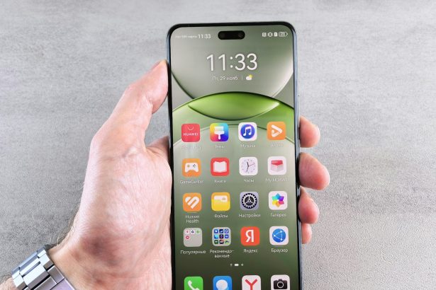 A person is holding a phone displaying its home screen.