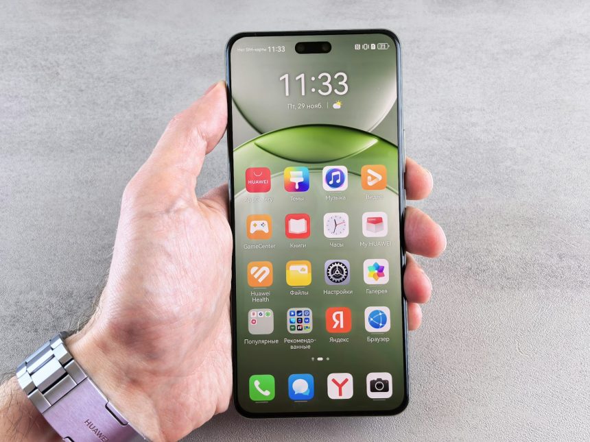 A person is holding a phone displaying its home screen.