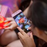 woman holding silver iphone 6