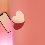 a cell phone with a heart cut out of it