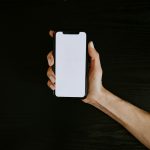 person holding white iphone 5 c