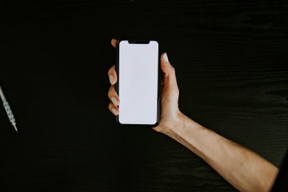 person holding white iphone 5 c