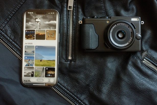 Smartphone and camera on black leather