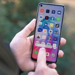 a person holding a cell phone in their hand