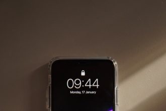 a cell phone sitting on top of a wall
