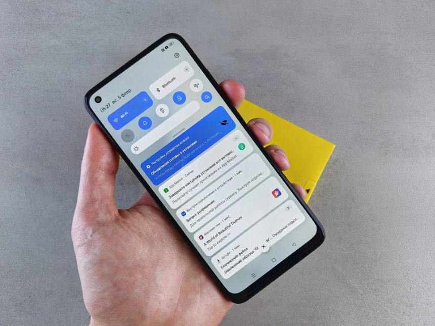 a person holding a cell phone in their hand